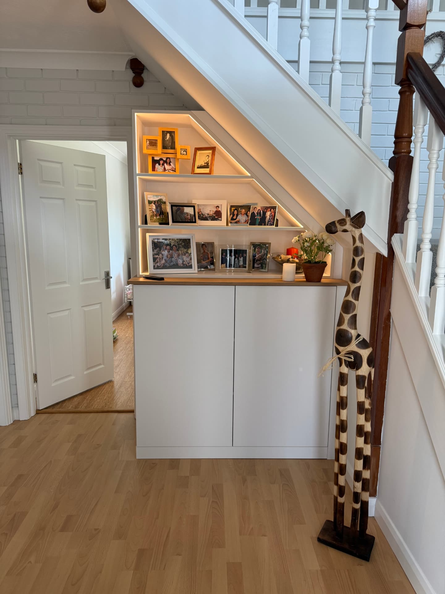 Bespoke under stairs cupboards and illuminated display shelving