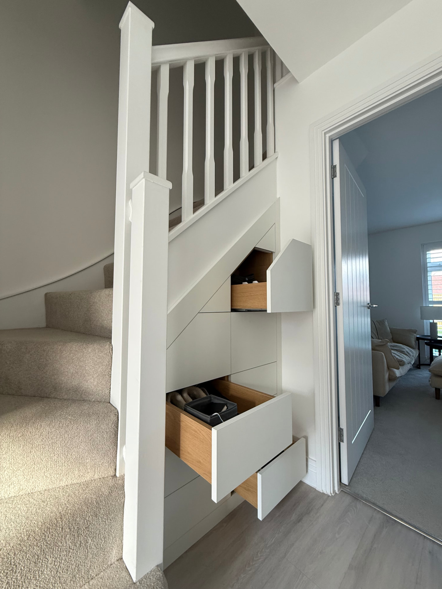 Made-to-measure white under stairs drawers with oak interiors